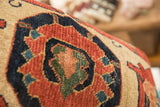 Dense hand-knotted pile of antique Bijar fragment, with terracotta, navy, and green geometric motifs.