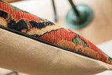 Close-up of antique Bijar fragment pillow's textured red, blue pile and beige backing.