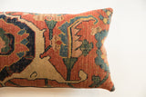 Complex terracotta, navy, and tan hand-knotted pattern on an antique Bijar fragment pillow.