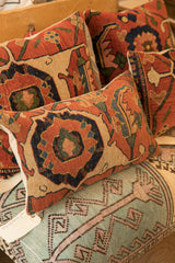 Antique Bijar rug fragment pillow with hand-knotted texture, rust, blue, beige motifs.