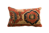 Antique Persian Bijar rug fragment pillow featuring geometric motifs in terracotta, navy, and tan, 20x12.