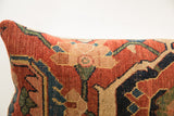 Textured pile detail of antique Bijar rug pillow with rust, deep blue, and green motifs.
