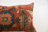 Antique Persian Bijar rug fragment pillow with rich red-orange, blue, green curvilinear pattern.