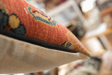 Antique Bijar fragment pillow side, highlighting its robust weave and black zipper closure.