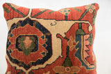 Detail of the antique Bijar pillow's hand-knotted pile with terracotta, navy, and green patterns.