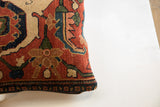 Bottom edge of the antique Bijar pillow, featuring a detailed dark blue and brick red border.