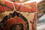 Detailed texture of an antique Persian Bijar rug fragment pillow with terracotta, tan, and navy geometric motifs.