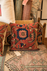 Antique Bijar rug pillow's corner, showcasing its finely woven border and red field pattern.