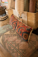 Antique Bijar rug pillow displaying ruby red, sapphire blue, and gold floral palmettes.