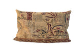 Oversized vintage Kerman rug fragment pillow featuring mythological motifs in soft beige and ruby.