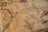 Textured Kerman rug fragment pillow with faded beige, dark blue, and red mythological motifs.