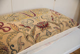 Detail view of beige vintage Kerman rug fragment pillow showing red, blue, golden mythological motifs.