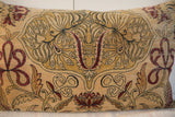 Close-up of the antique Persian Kerman pillow's intricate red floral and black vine design.