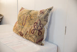 Textured cream and maroon mythological motifs on a vintage Persian Kerman pillow.