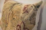 Antique Persian Kerman rug pillow fragment with low-pile texture, faded red mythological motifs.