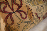 Hand-knotted vintage Kerman fragment pillow with red, gold, and beige curvilinear pattern.