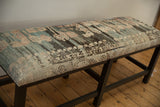 Textured vintage Turkish rug fragment showing wear down to knot-heads and colorful geometric patterns.