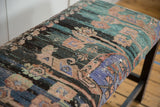 Angled close-up of the vintage Turkish rug fragment's worn texture in charcoal, teal, and lavender.