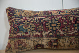 Worn hand-knotted texture with visible foundation, showing faded red, blue, and tan hues.