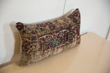 Corner and side view of a vintage rug pillow showing its plush form and texture.