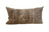 Distressed vintage rug fragment pillow showcasing faded hand-knotted Persian Malayer patterns in muted earth tones, 17x30.