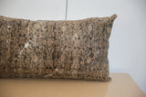 Vintage Malayer rug fragment pillow, highlighting distressed texture and faded brown tones.