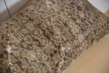 Distressed texture of the hand-knotted Malayer rug pillow, showcasing faded patterns and visible foundation.