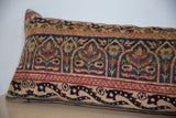 Hand-knotted Kerman fragment pillow detail: deep teal, ruby red, gold arching motifs.