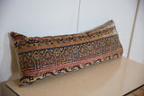 Vintage Kerman lumbar pillow showing intricate arched motifs in indigo, gold, and red.