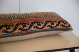 Vintage rug fragment lumbar pillow, featuring ornate curvilinear Kerman pattern and zipper.