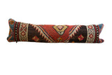 Vintage Kurdish rug fragment lumbar pillow with geometric motifs in rust, brown, and blue.