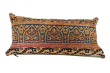 Vintage hand-knotted Persian Kerman rug fragment pillow with gold, deep red, and sapphire blue floral motifs.