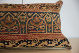 Red, gold, and teal floral palmette design on vintage Persian Kerman pillow fragment.