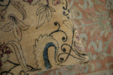Close-up on the saffron yellow weave and art nouveau design of an antique Kerman pillow.