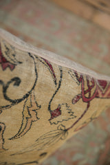 Beige zipper detail on a saffron yellow antique Kerman rug fragment pillow.