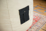 Black swappable pocket with snap on the natural hemp canvas bean bag chair.