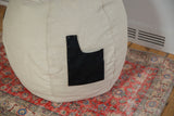 Side view of the hemp bean bag chair showing its swappable black pocket with snaps.