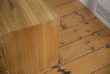 Corner detail of the solid oak nightstand showing the fine vertical wood grain.