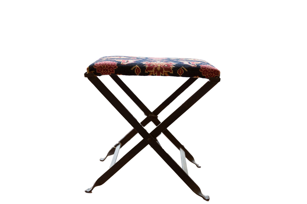 Vintage Rug Fragment Footstool, dark blue, red, ivory patterned textile, folding metal base.