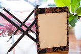 Hand-knotted vintage rug fragment's geometric pattern in deep red and blue with copper nails.