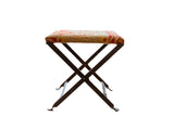 Vintage rug fragment footstool with a rustic metal base and red, yellow, beige geometric pattern. 12x16 inches.