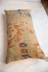 Textured close-up of the antique Persian Sultanabad pillow, revealing hand-knotted floral vinery.