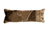 Vintage Turkish Oushak rug fragment lumbar pillow, distressed brown and beige geometric design.