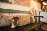 Vintage Oushak rug fragment lumbar pillow with brown geometric pattern and bright pink backing.