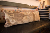 Distressed texture and subtle faded pattern of the vintage Turkish rug fragment pillow.