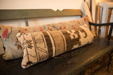 Textured brown and cream geometric pattern on a vintage Turkish Oushak lumbar pillow.