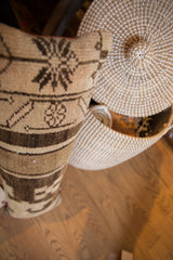 Lower half of vintage Turkish Oushak lumbar pillow, showing textured brown and beige geometric patterns.