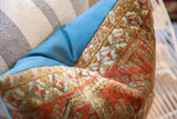 Textured antique Belouch fragment pillow, showcasing coral and earthy geometric motifs.