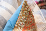 Distressed tribal patterns on antique Belouch rug fragment pillow, contrasting blue side.