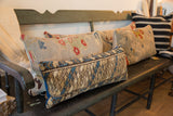Textured geometric pattern in blue, brown, and beige on the vintage rug lumbar pillow.